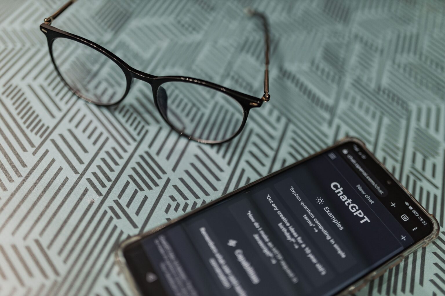 Smartphone displaying ChatGPT on a table.