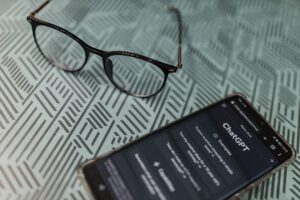 Smartphone displaying ChatGPT on a table.